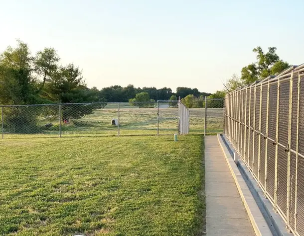 Outdoor fenced play yard for dogs at pet kennel near Scott Air Force Base IL